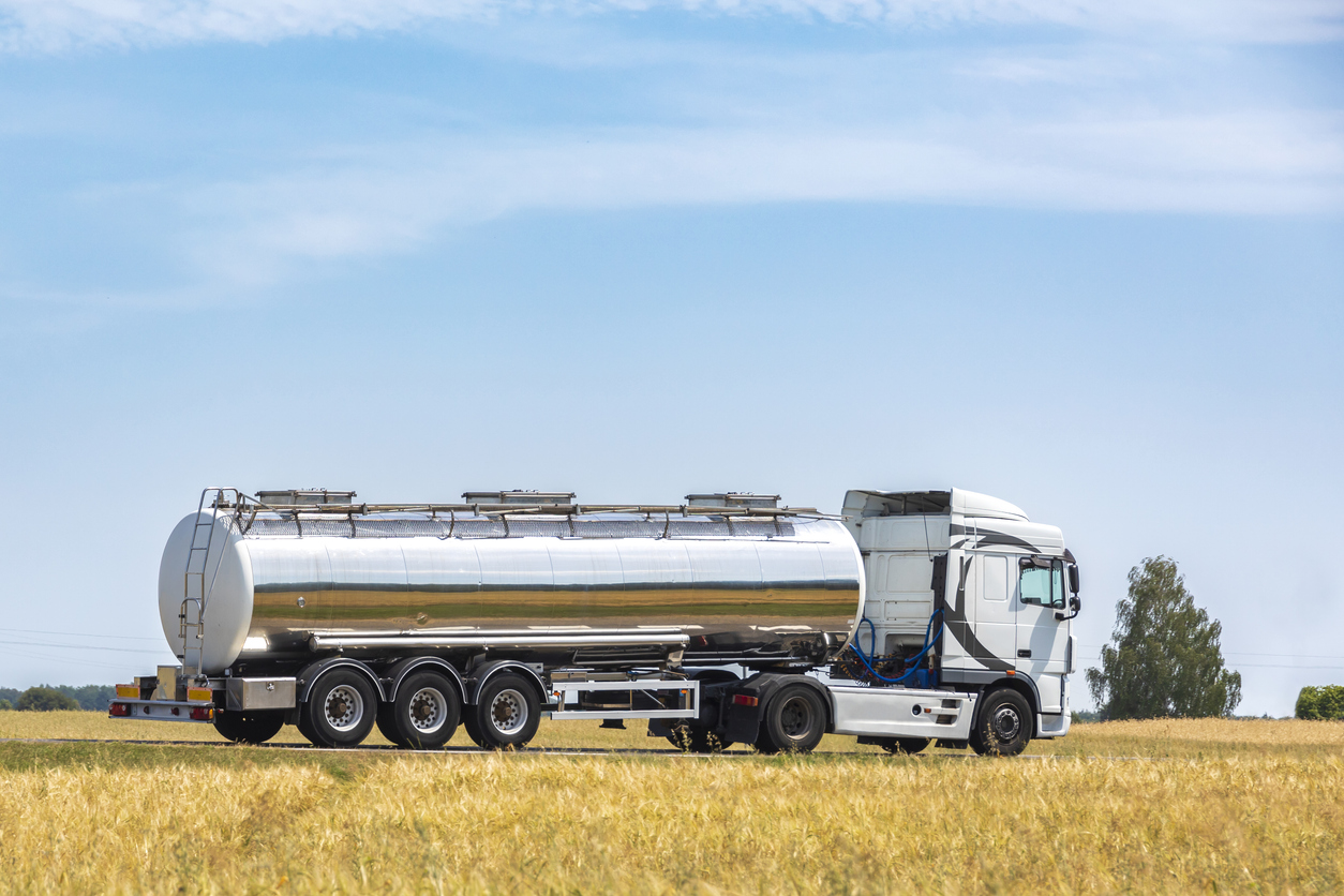 truck transporting fuel through a wheat field